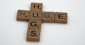 Scrabble tiles spelling out Huge Hugs