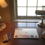 View of desk with computer at window